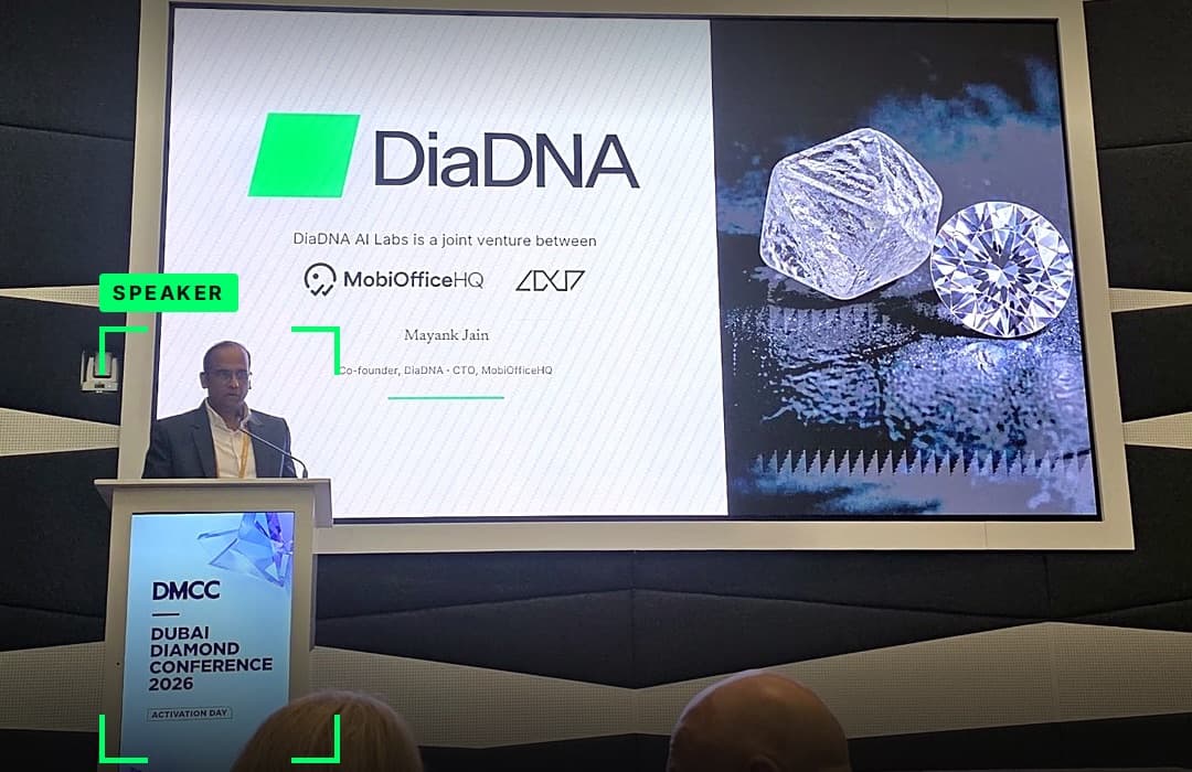 Mayank Jain speaking at the DMCC Dubai Diamond Conference 2026 podium, with the DiaDNA title slide on screen